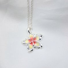 This Sterling Silver Rainbow Plumeria Necklace is the perfect accessory for any special occasion. Featuring vibrant colors and delicate craftsmanship, this Hawaiian jewelry is perfect for any fan of elegant jewelry. An ideal gift for yourself or a special someone, this plumeria pendant is sure to make a lasting impression. - Comes ready to wear on a 925 sterling silver chain of you choice length. Comes standard on a box style chain.  - solid sterling silver plumeria flower pendant accented with a cz   Approx 20 mm in size Custom made to order so yours may look slightly different from the above pictures. Due to different monitors and settings colors may appear slightly different. Multicolor Flower-shaped Jewelry For Gift, Multicolor Flower-shaped Jewelry Gift, Yellow Sterling Silver Flower Jewelry, Sterling Silver Flower Charm Necklace For Mom, Silver Flower Charm Necklace For Her, Silver Flower Necklace For Mom, Silver Flower Necklace Gift For Her, Silver Flower Charm Necklace As Gift For Her, Silver Flower Necklace Gift For Mom