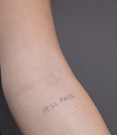 a person's arm with the word tili pass tattooed on its left arm