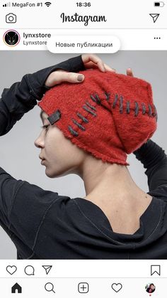 a woman wearing a red hat with black writing on the front and back of her head