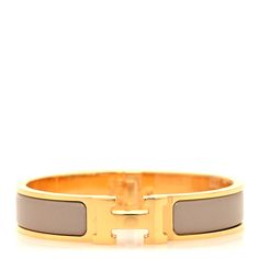 This is an authentic HERMES Enamel Narrow Clic Clac H Bracelet PM in Marron Glace. This is a chic bracelet that features a gold plated band with a hinge on one side and opens with a swivel Hermes "H" on the prominent side. Around the band is a strip of beige enamel set in the metal. H Bracelet, Hermes Bracelet, Hermes Jewelry, Chic Bracelet, Gold Plate, Plating, Pouch, Things To Sell, Band