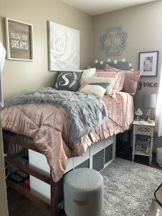 a bedroom with a bed, rugs and pictures on the wall above it is shown