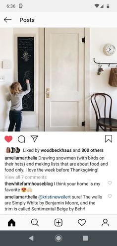 a person writing on a blackboard in front of a door