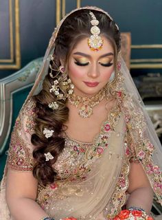 a woman in a bridal gown with flowers on her head