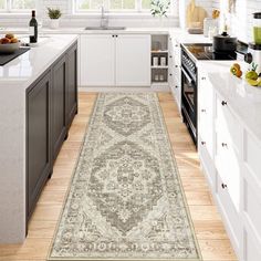 a large rug in the middle of a kitchen with white cabinets and counter top space