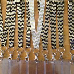 six lanyards with black and white chevron design on them are lined up in rows