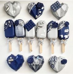 there are many blue and white lollipops in the shape of heart shaped candies