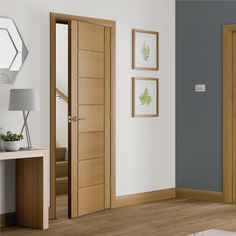 an open wooden door in a white room