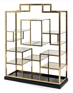 a gold and black shelf with glass shelves on each side, in front of a white background