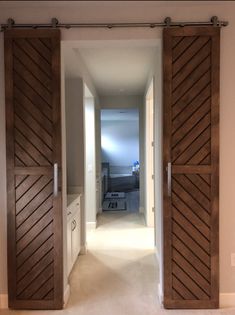 an open door leading to a bedroom with white walls and carpeted flooring in front of it