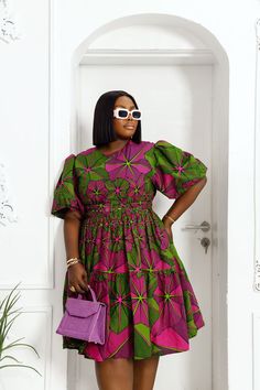 Look amazing and feel confident in the BUNMI midi dress! This African print design features puff sleeves, ensuring you'll be an eye-catching sight no matter where you go. Whether you want to make a statement in the spotlight or elevate your style at work or a special event, this dress promises to have you looking your best. FEATURES.* 100% African Wax Cotton* Midi dress with puff sleeve shoulder* Dress is Lined.* Back Zipper, Detachable belt included.* Side pockets* Dress is 43’’ long* Model Is