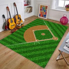 a baseball field area rug with guitars and guitars on the floor in front of it