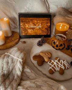 some cookies and candles are on a tray next to a sign that says ginger god