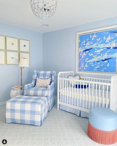 a baby's room with blue and white decor