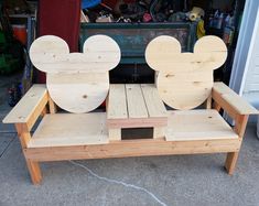 a wooden bench made to look like mickey mouse heads