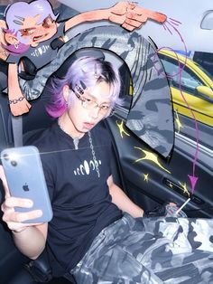 a woman with purple hair sitting in a car looking at her cell phone while holding an iphone