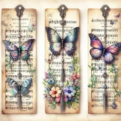 three tags with butterflies on them and music sheets in the background, one is decorated with flowers