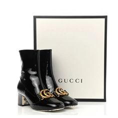 This Is A Fabulous Pair Of Authentic Gucci Patent Calfskin Double G Ankle Boots 37 In Black. These Boots Are Mid-Length On The Leg And Crafted Of Black Patent Leather. These Boots Feature A 2.25 Inch Block Heel, An Antique Gold Gg Logo, A Blue Rosebuds Printed Design In The Insole And Outsole Of Boots And A Zipper On The Inside For Easy On And Off Making Them Perfect Boots For Everyday Wear, Only From Gucci! Brand New, Never Worn, Low Ball Offer Will Not Be Responded To Poshmark Authenticate All Gucci Ankle Boots, Ankle Combat Boots, Gucci Boots, Studded Ankle Boots, Gucci Brand, Patent Leather Boots, Ankle Socks Women, Womens Combat Boots, Block Heel Ankle Boots