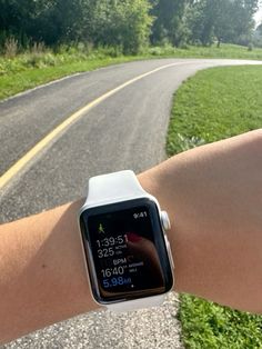 an apple watch on someone's arm showing the time and location for their run