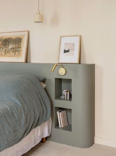 a bed with a book shelf next to it on the side of the bed,