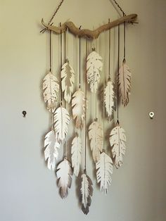 a wall hanging made out of branches and leaves