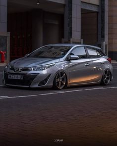 a silver car is parked on the street