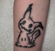 a tattoo with a cartoon character on it's arm and an arrow in the middle