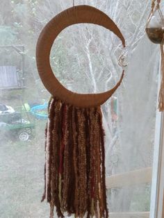 a wind chime hanging in front of a window