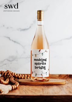 a bottle of wine sitting on top of a wooden cutting board next to some nuts