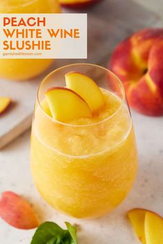 peach white wine slushie in a glass with sliced peaches on the side