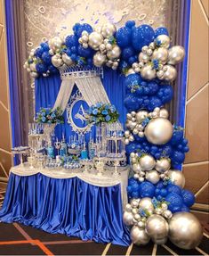 a blue and silver wedding arch with balloons