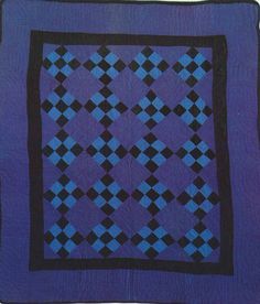 a blue and black quilt with squares on it