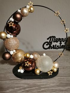 a christmas ornament with gold, white and brown ornaments on it's side