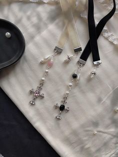 a pair of black and white earrings sitting on top of a table