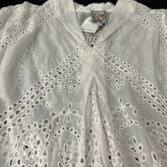 Johnny Was Really Goes Elegant With Its Cut Cloth Cotton Lace. The Measurements Are Seen In The Photos. It Has A V-Neck, Followed By A Vertical Pleat Down The Front. This Tunic Has Never Been Worn. The White Color Looked Better On The Hanger Than On Me! V-neck Blouse With Lace Trim For Daywear, Casual V-neck Eyelet Blouse, V-neck Broderie Anglaise Blouse For Daywear, Elegant V-neck Blouse With Broderie Anglaise, Daywear V-neck Top With Broderie Anglaise, Elegant Short Sleeve Tops With Cutwork Hem, V-neck Broderie Anglaise Top For Daywear, Summer V-neck Top With Broderie Anglaise, Spring V-neck Eyelet Blouse