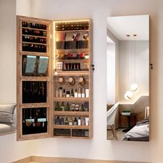 an open wooden medicine cabinet sitting on top of a hard wood floor next to a mirror