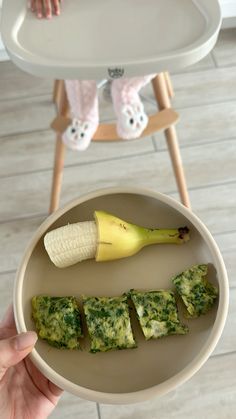 a person holding a plate with food on it and a banana in the other hand