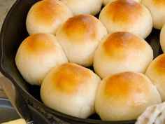 a pan filled with bread rolls on top of a stove