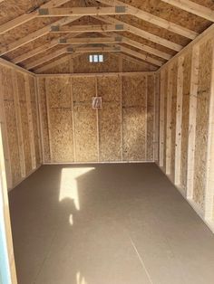 the inside of a large wooden building with no doors and walls in place for storage