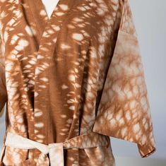 Transform your shower or bath into a spa-like experience. Wrap yourself in this entirely handcrafted kimono-style robe. Using a recipe of all-natural ingredients, this 100% cotton robe is hand loomed, then hand-dyed. Feel the care and artistry shine through, elevating an everyday moment. Crafted by artisans with Manushi, meaning "energetic woman" in Nepali. Cotton Kimono With Natural Dye And Kimono Sleeves, Cotton Kimono With Natural Dye And Relaxed Fit, Spring Loungewear Kimono With Natural Dye, Brown Cotton Kimono, Relaxed Fit Cotton Robe With Kimono Sleeves, Beige Cotton Kimono With Relaxed Fit, Brown Cotton Kimono With Kimono Sleeves, Chain Scarf, Candle Wall Decor