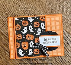 an orange and black halloween card with pumpkins