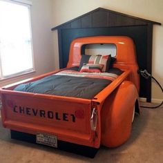 an orange truck bed in a room with two windows