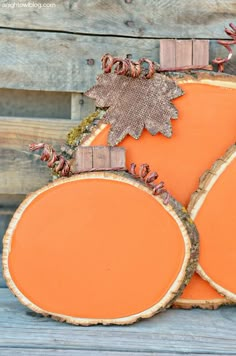 three pieces of wood with leaves on them