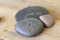 some rocks with writing on them are sitting on a table and the words carving rocks with a dremel