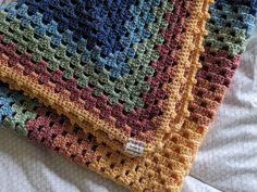 This classic granny square stroller blanket is made from a soft acrylic yarn in a muted rainbow color perfect for both boys and girls.  If you are local to the Rochester, NY area and would like to pick up, please message me *before* placing your order. I will waive your shipping fee *or* add a small surprise item! Crochet Grandma Square, Gender Neutral Rainbow, Muted Rainbow, Neutral Rainbow, Crochet Granny Square Blanket, Crochet Granny Square, Granny Square Blanket, Stroller Blanket, Square Blanket