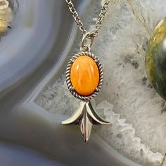 Bright, Beautiful And Dainty Carolyn Pollack Vintage Southwestern Style Sterling Silver Oval Orange Spiny Oyster Cabochon Single Squash Blossom Pendant And Necklace For Women. The Bright Stone Is Set In A Rope Bezel With Prongs With A Lovely Single Squash Blossom. The 16" - 20" Adjustable Link Chain Is Included. This Design Has An Oxidized Finish With Beautiful Polished Accents. Measure 1/2" X 1 12" (Inc Bail) And Weighs Approx 9.5 Grams. ** Stones Are Natural Therefore Matrix And Color Shades May Vary. ** ** If Oxidation Or Tarnish Darkens The Piece Over Time, Use A Polishing Cloth To Restore To Desired Finish. ** (Cppn16p25) Vintage Native American Jewelry, Squash Blossom, Spiny Oyster, Southwestern Style, Native American Jewelry, Necklace For Women, Matrix, Womens Jewelry Necklace, Favorite Jewelry