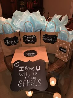 small bags with chalkboard saying i love you and some tea lights on the table