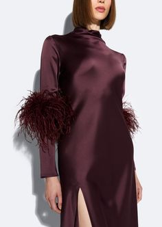 Featured In The Fall 2024 Collection This doubleface satin dress features a draped neck with long sleeves, slit detail and feathers on the sleeves. Materials: 61% Acetate, 39% Viscose, 100% Real Ostrich Feathers Care: Professional Care Only Fit: True to Size Model is 5'10" and Wearing a 2 Dress With Feathers, Bias Dress, Dress Design Sketches, Feather Dress, High Neck Long Sleeve, Ostrich Feathers, Plum Purple, Runway Collection, Satin Dress