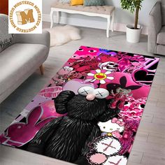 a living room area rug with a black cat and pink flowers on the floor in front of a couch