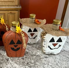 three decorated pumpkins sitting on top of a counter