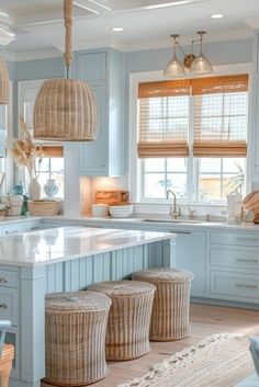 a kitchen filled with lots of blue cabinets and counter top covered in wicker baskets